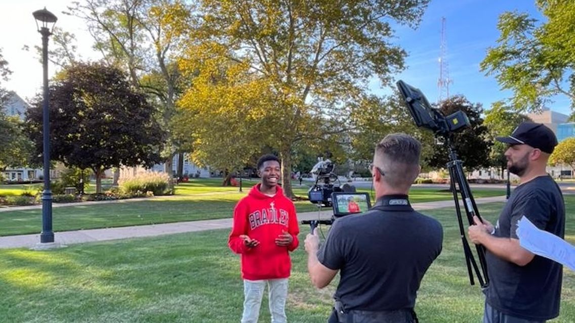 Caleb Purnell on campus with two College Tour videographers