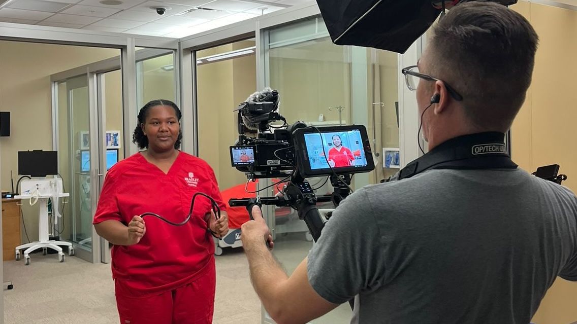 Taylor Hillman poses for a College Tour videographer in BU's state-of-the-art nursing simulation lab.