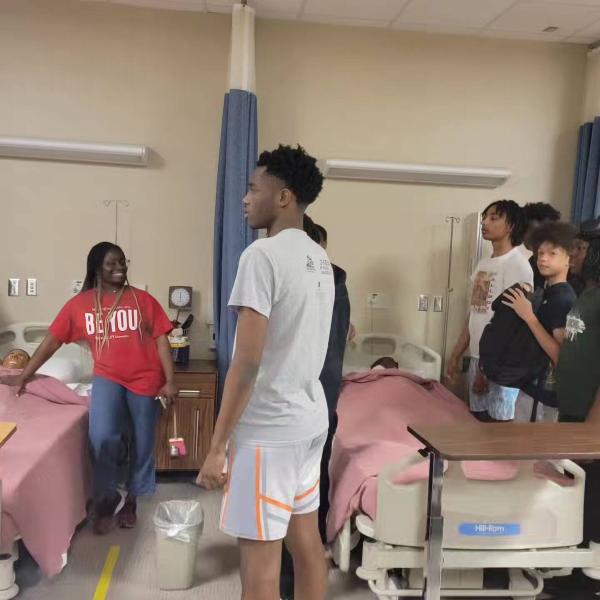 Dr. Sokonie Reed and GLOW students tour the Nursing simulation space.